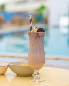 a drink in a glass sitting on a table at Hotel Sapphire in Mombasa