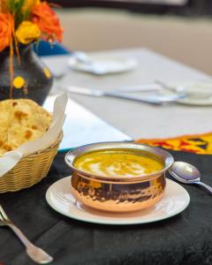 a bowl of soup on a plate on a table at Hotel Sapphire in Mombasa