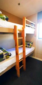 A bed or beds in a room at Stay Hostel Rotorua