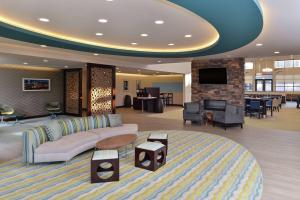 a hotel lobby with a couch and a tv at Homewood Suites by Hilton Cincinnati/Mason in Mason