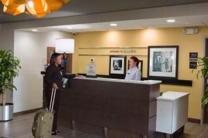 a man and a woman standing at a reception desk at Hampton Inn & Suites - Knoxville Papermill Drive, TN in Knoxville