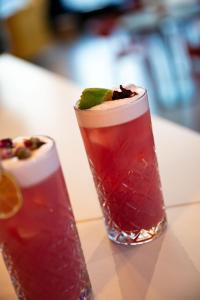 two cocktails sitting on a table next to each other at Aloft Strasbourg Etoile in Strasbourg