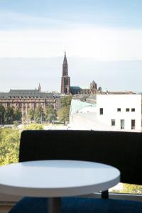 a white table and a view of a city at Aloft Strasbourg Etoile in Strasbourg