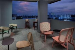 a room with chairs and tables and a view of a city at Tru By Hilton Miami Airport South Blue Lagoon, Fl in Miami