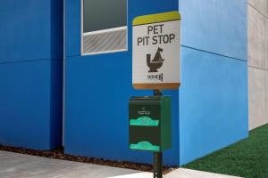 a sign for a pet pitstop in front of a building at Tru By Hilton Miami Airport South Blue Lagoon, Fl in Miami