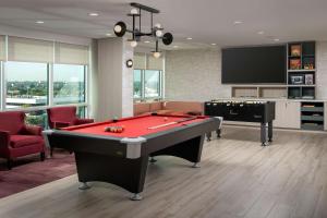 a living room with a pool table and a tv at Tru By Hilton Miami Airport South Blue Lagoon, Fl in Miami