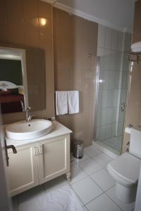 a bathroom with a sink and a shower and a toilet at Hotel Taksim Home in Istanbul