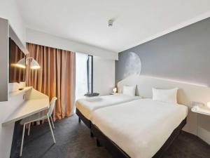 ibis Styles Paris Charles de Gaulle Airport tesisinde bir odada yatak veya yataklar