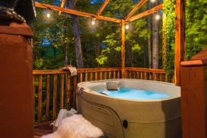 jacuzzi na tarasie w lesie w obiekcie CABIN in a GATED RESORT with SEASONAL RESORT POOL w mieście Pigeon Forge