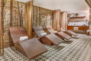 a row of brown chairs in a room with a piano at Live Aqua Ciudad de Mexico Bosques de las Lomas in Mexico City