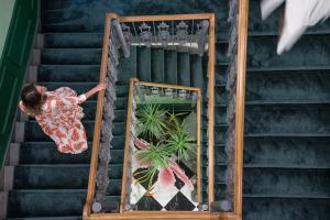 a woman standing on a staircase with a mirror at Hotel La Gemma in Florence