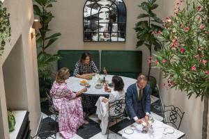 a group of people sitting at a table in a restaurant at Hotel La Gemma in Florence