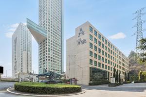 a tall building with a statue in front of it at Live Aqua Ciudad de Mexico Bosques de las Lomas in Mexico City