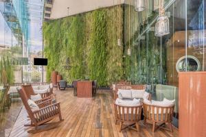 a lobby with chairs and a green wall at Live Aqua Ciudad de Mexico Bosques de las Lomas in Mexico City