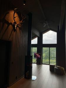 uma sala de estar com uma grande janela e um piano em Sogndal Chalet em Sogndal