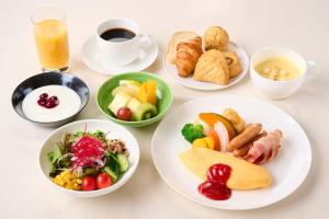 a table with plates of food and a cup of coffee at Asakusa Tobu Hotel in Tokyo