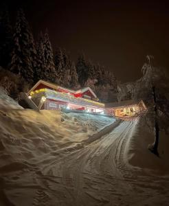 a ski lodge in the snow at night at Comfortable Villa In Lillehammer in Lillehammer