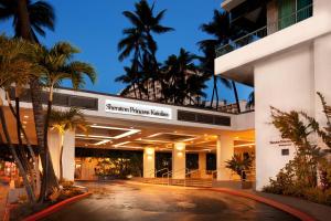 a building with palm trees in front of it at Sheraton Princess Kaiulani in Honolulu