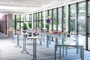 a rendering of a lobby with tables and windows at Hilton Strasbourg in Strasbourg