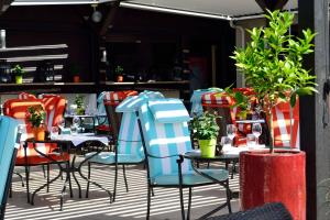 a group of tables and chairs on a patio at Hilton Strasbourg in Strasbourg