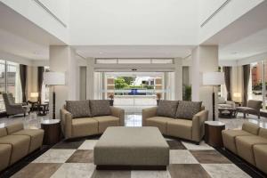 a lobby with couches and chairs and a table at Hilton Garden Inn Tuxtla Gutierrez in Tuxtla Gutiérrez