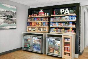 a room with two refrigerators and a shelf with drinks at Hampton Inn Philadelphia/King of Prussia - Valley Forge in King of Prussia