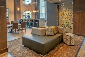 a living room with a couch sitting on a rug at Hampton Inn & Suites San Jose Airport in San Jose