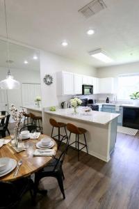 a kitchen and dining room with a table and chairs at Stylish & Renovated Modern Farmhouse Boutique Apt in Gainesville