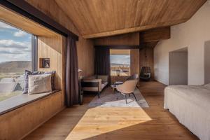 a bedroom with a bed and a desk and a window at Highland Base Kerlingarfjöll in Kerlingarfjoll