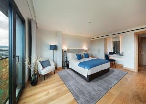 A bed or beds in a room at Tower Suites by Blue Orchid