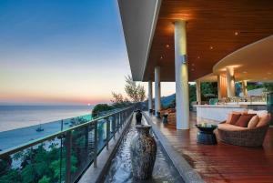 a balcony of a house with a view of the ocean at Wyndham Grand Phuket Kalim Bay in Patong Beach