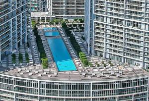 an overhead view of a large building with a swimming pool at Icon Luxury 34th Floor Amazing Oceanview, Brickell in Miami