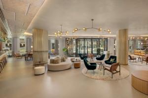 a living room with chairs and furniture in a building at Canopy by Hilton London City in London