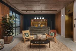 a living room with two chairs and a table at Canopy by Hilton London City in London