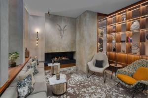 a living room with a couch and a fireplace at Canopy by Hilton London City in London