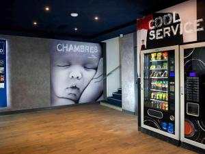 a store with a large advertisement on the wall at Ibis Budget Strasbourg Centre Gare in Strasbourg