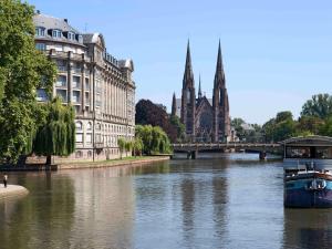 a river with a bridge and a church and a river at Ibis Budget Strasbourg Centre Gare in Strasbourg