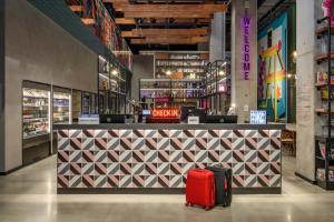 a store with two suitcases standing in front of a counter at Moxy Lisboa Oriente in Lisbon