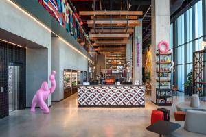 a pink mannequin in the lobby of a store at Moxy Lisboa Oriente in Lisbon