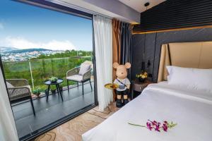 Un pat sau paturi într-o cameră la New Century Dalat Hotel