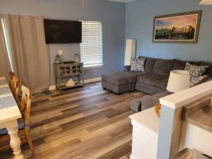 a living room with a couch and a table at McDrifty's Getaway in Panama City Beach