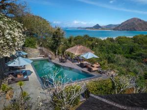 an image of a swimming pool with a view of the ocean at Sempiak Seaside Resort in Selong Belanak