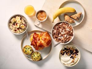 a table with plates of food and bowls of breakfast foods at Residence Inn by Marriott Harrisburg Carlisle in Carlisle