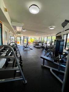 a gym with several treadmills and cardio machines at Luana Waikiki Park Views in Honolulu