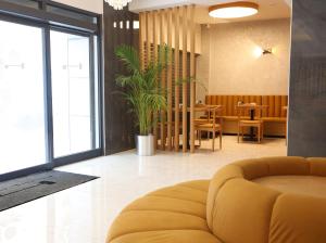 a living room with a yellow couch and a table at Riva Hotel Alsancak in İzmir