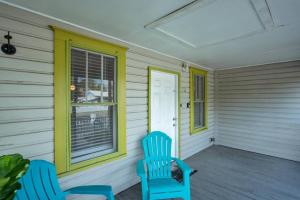 a porch with two blue chairs and a window at 1940 cottage seen on FYI, 2bd 2ba in Gainesville