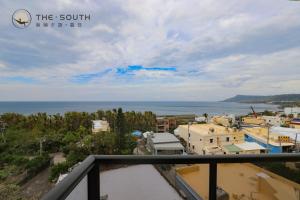 a view of the ocean from the balcony of a building at The South-Sunset in Hengchun South Gate