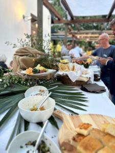 a table topped with plates of food and bowls of food at Aquasole in Mercallo