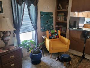 sala de estar con silla amarilla y escritorio en A rest after a day in the Death Valley desert, en Scranton