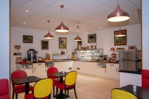 a restaurant with tables and chairs in a room at K Hotel in Strasbourg